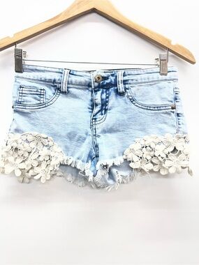 Kiss & Cry denim‎ shorts with white floral lace applique details.
